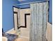 Bathroom with shower/tub combo, blue walls, and updated vanity at 1025 Carolina Rd. # F2, Conway, SC 29526