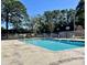 Community pool with surrounding patio and trees at 1025 Carolina Rd. # F2, Conway, SC 29526