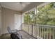 Screened balcony with two chairs and wooded views at 5750 Oyster Catcher Dr. # 1134, North Myrtle Beach, SC 29582
