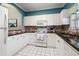 White kitchen with granite countertops and stainless steel appliances at 5750 Oyster Catcher Dr. # 1134, North Myrtle Beach, SC 29582