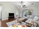 Living area featuring a sectional sofa, balcony access, and wood floors at 5750 Oyster Catcher Dr. # 1134, North Myrtle Beach, SC 29582