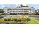 Two-story condo building with ample parking and lush landscaping at 5750 Oyster Catcher Dr. # 1134, North Myrtle Beach, SC 29582