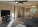 Spacious living room showcasing hardwood floors, ample natural light, and a large TV at 5801 Oyster Catcher Dr. # 413, North Myrtle Beach, SC 29582