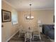 Bright dining area with glass-top table and four chairs, adjacent to the kitchen at 5801 Oyster Catcher Dr. # 413, North Myrtle Beach, SC 29582