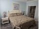 Spacious bedroom with king-size bed, nightstands, and ensuite bathroom access at 5801 Oyster Catcher Dr. # 413, North Myrtle Beach, SC 29582