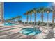 Community pool and hot tub area with lounge chairs and palm trees at 1625 S Ocean Blvd. # 1305, North Myrtle Beach, SC 29582