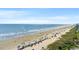 Aerial view of a beach with many people and umbrellas at 1625 S Ocean Blvd. # 1305, North Myrtle Beach, SC 29582