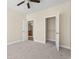 Bedroom with carpet flooring, ample closet space, and access to bathroom at 84 S Addison Cottage Way # 213, Murrells Inlet, SC 29576
