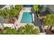 Community pool with surrounding lounge chairs and palm trees at 84 S Addison Cottage Way # 213, Murrells Inlet, SC 29576