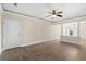 Living room with tile floors, ceiling fan and access to balcony at 84 S Addison Cottage Way # 213, Murrells Inlet, SC 29576