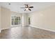 Bright bedroom featuring tile floors, large window, and ceiling fan at 84 S Addison Cottage Way # 213, Murrells Inlet, SC 29576