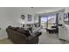 Living room with comfy leather sofas, a large TV, and sliding glass doors leading to a balcony at 9621 Shore Dr. # G219, Myrtle Beach, SC 29572