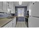 Galley kitchen with white cabinets, stainless steel appliances, and blue walls at 9621 Shore Dr. # G219, Myrtle Beach, SC 29572
