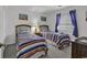 Bedroom with two twin beds, nightstand, and colorful striped bedding at 9621 Shore Dr. # G219, Myrtle Beach, SC 29572