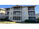Three-story building with screened balconies and landscaping at 4278 Pinehurst Circle # W2, Little River, SC 29566