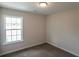 Simple bedroom with carpet flooring and a window at 318 Barn Owl Way, Conway, SC 29527