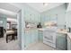 White appliances and teal cabinets in open kitchen at 7300 Porcher Dr. # 8, Myrtle Beach, SC 29572