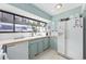 Kitchen with white appliances, teal cabinets, and a window at 7300 Porcher Dr. # 8, Myrtle Beach, SC 29572