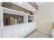 Built-in white shelving unit with books and decor at 7300 Porcher Dr. # 8, Myrtle Beach, SC 29572