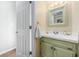 Charming half bathroom with light green vanity and white tile at 7300 Porcher Dr. # 8, Myrtle Beach, SC 29572