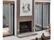 Brick fireplace with a black metal screen and artwork above at 7300 Porcher Dr. # 8, Myrtle Beach, SC 29572