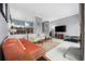 Living room with orange leather sofa and off-white armchairs at 7300 Porcher Dr. # 8, Myrtle Beach, SC 29572