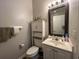 Small bathroom with toilet, sink, and linen cabinet at 1525 Lantern Rest Dr. # 301, Myrtle Beach, SC 29579