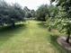 View of a community lawn with trees and walking path at 1525 Lantern Rest Dr. # 301, Myrtle Beach, SC 29579