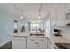 Modern kitchen with white cabinets, stainless steel appliances, and quartz countertops at 4105 S Ocean Blvd. S # 102, North Myrtle Beach, SC 29582