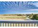 View from deck showcasing ocean, beach access, and sandy dunes at 4105 S Ocean Blvd. S # 102, North Myrtle Beach, SC 29582