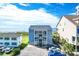 Oceanfront view of a three-story building with parking and beach access at 4105 S Ocean Blvd. S # 102, North Myrtle Beach, SC 29582