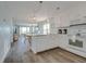 Modern kitchen with white cabinets, stainless steel appliances, and hardwood floors at 4105 S Ocean Blvd. S # 102, North Myrtle Beach, SC 29582