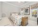Cozy bedroom with floral bedding, large windows, and a ceiling fan at 204 5Th Ave. N, North Myrtle Beach, SC 29582