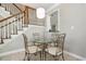 Small breakfast nook with glass table and four chairs near staircase at 204 5Th Ave. N, North Myrtle Beach, SC 29582