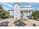 Two-story waterfront home with gray siding and orange door at 204 5Th Ave. N, North Myrtle Beach, SC 29582