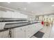 Large kitchen island with granite countertop and white cabinets at 204 5Th Ave. N, North Myrtle Beach, SC 29582