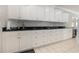 Long kitchen counter with white cabinets and granite countertop at 204 5Th Ave. N, North Myrtle Beach, SC 29582