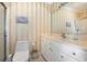 Clean bathroom with a toilet, sink, and striped wallpaper at 204 5Th Ave. N, North Myrtle Beach, SC 29582