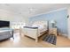 Main bedroom with a king-size bed and light blue accent wall at 204 5Th Ave. N, North Myrtle Beach, SC 29582