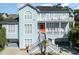 Two-story light blue house with a large front porch and white railings at 204 5Th Ave. N, North Myrtle Beach, SC 29582