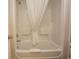 Clean bathroom with tub shower combo and white shower curtain at 6804 N North Ocean Blvd. # 933, Myrtle Beach, SC 29572