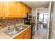 Kitchen boasts wood cabinets, tile backsplash, and stainless steel appliances at 6804 N North Ocean Blvd. # 933, Myrtle Beach, SC 29572