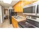 Full kitchen with stainless steel appliances and wood cabinetry at 6804 N North Ocean Blvd. # 933, Myrtle Beach, SC 29572