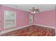 Charming bedroom with pink walls and wood-look flooring at 676 Oxbow Dr., Myrtle Beach, SC 29579