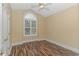 Charming bedroom with wood flooring, a ceiling fan, and an arched window at 676 Oxbow Dr., Myrtle Beach, SC 29579