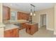 Open concept kitchen with island and wood cabinetry at 676 Oxbow Dr., Myrtle Beach, SC 29579