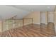Upstairs hallway with wood flooring and access to bedrooms and additional living space at 676 Oxbow Dr., Myrtle Beach, SC 29579