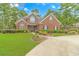 Brick house with manicured lawn and circular driveway at 676 Oxbow Dr., Myrtle Beach, SC 29579