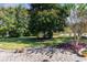 Spacious backyard with lush lawn, mature trees, and a brick patio area at 336 Piedmont Ave., Myrtle Beach, SC 29577