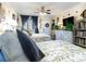Spacious bedroom with two twin beds, ceiling fan, and access to balcony at 200 76Th Ave. N # 411, Myrtle Beach, SC 29572